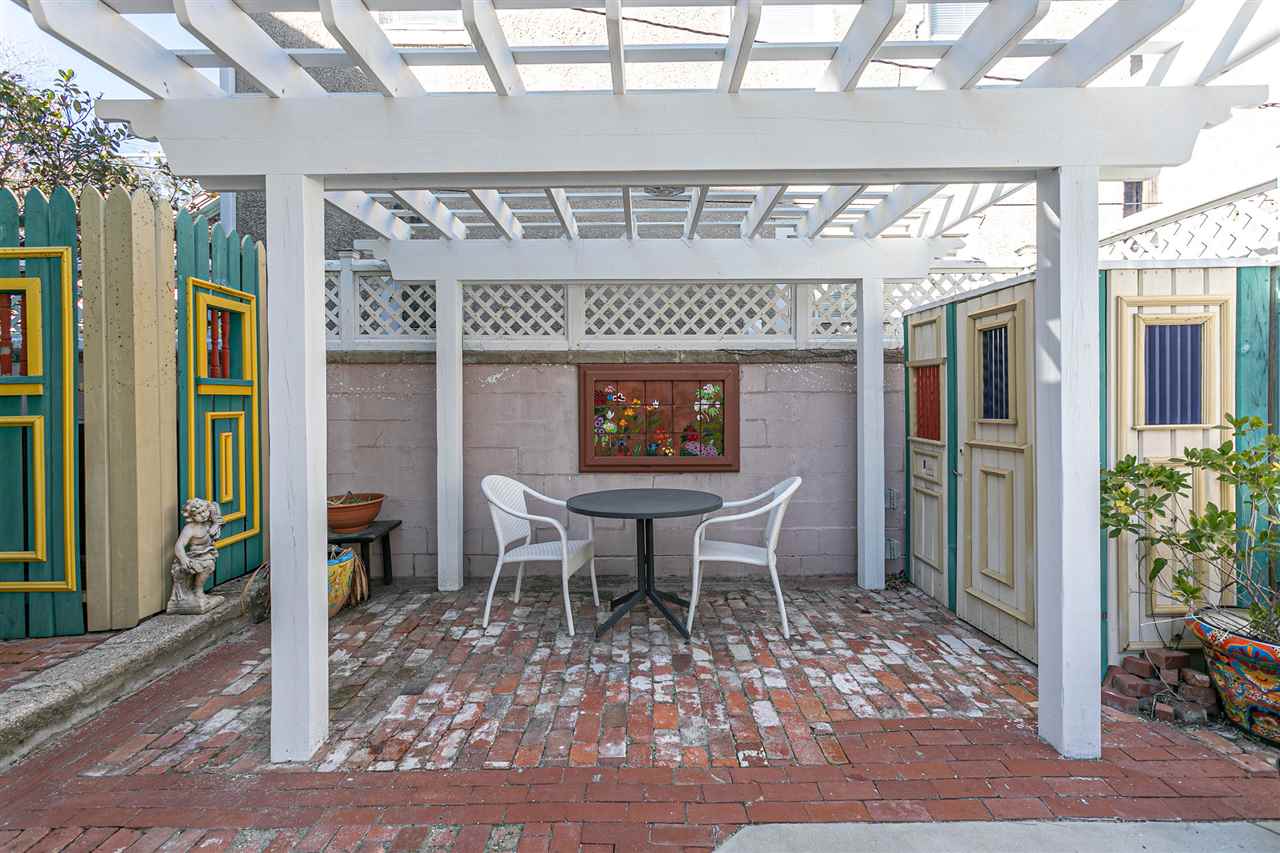 63 Marine Street St. Augustine, FL 32084 - Photo 13 of 42 a dining room with furniture wooden floor and a rug