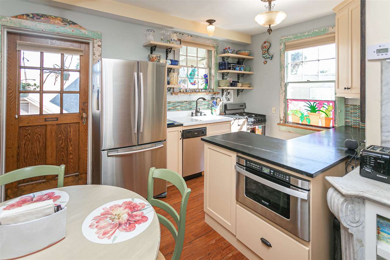 63 Marine Street St. Augustine, FL 32084 - Photo 22 of 42 a kitchen with a stove a refrigerator and a window