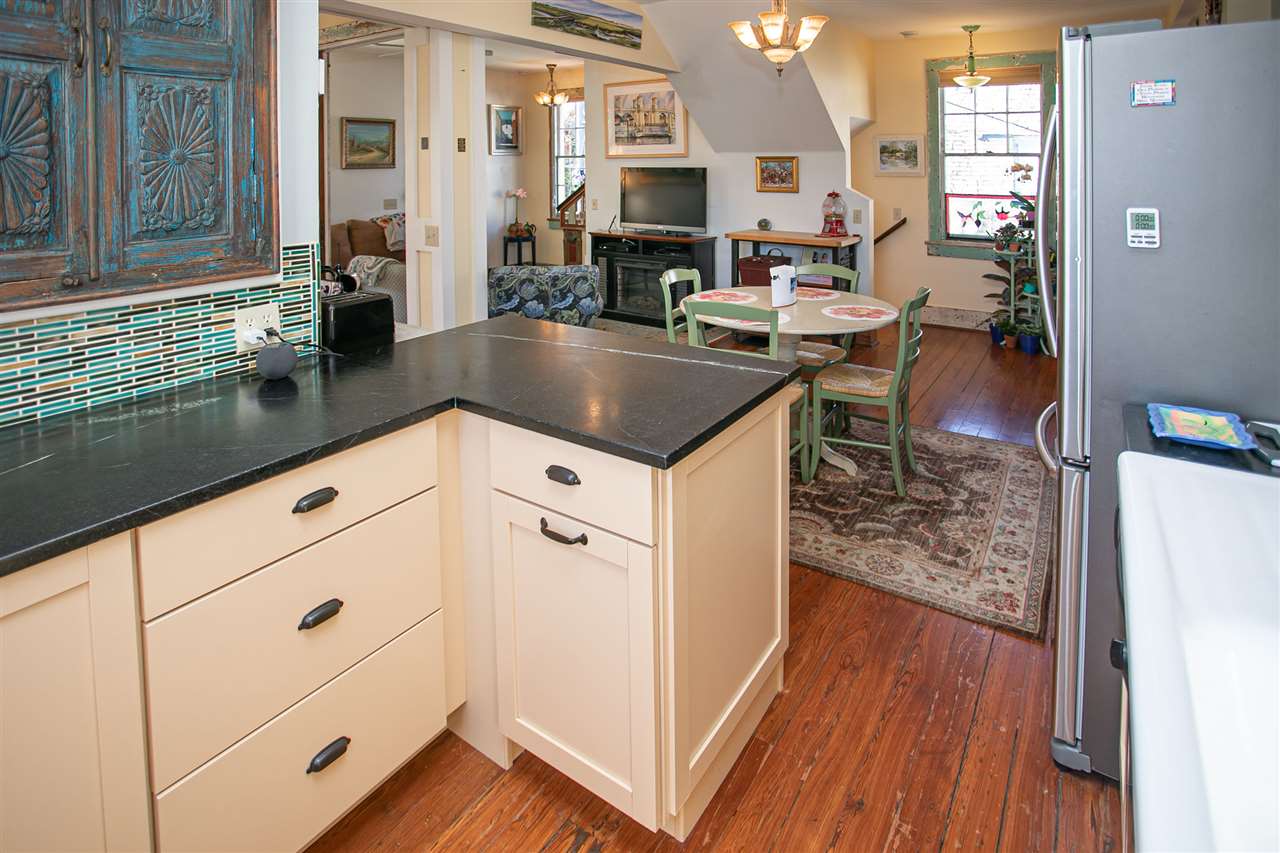 63 Marine Street St. Augustine, FL 32084 - Photo 24 of 42 a kitchen with stainless steel appliances granite countertop a sink stove and wooden floor