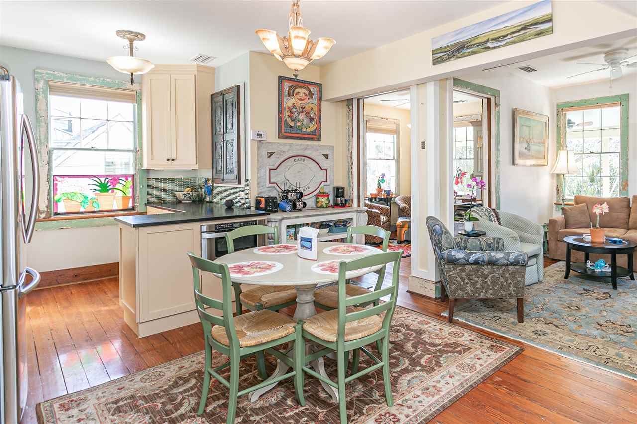 63 Marine Street St. Augustine, FL 32084 - Photo 25 of 42 a dining room with furniture a chandelier and wooden floor