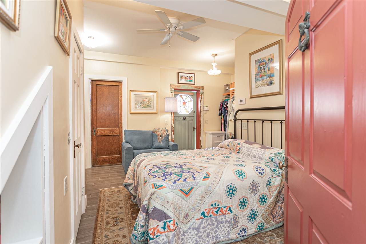 63 Marine Street St. Augustine, FL 32084 - Photo 5 of 42 a bedroom with a bed and a mirror