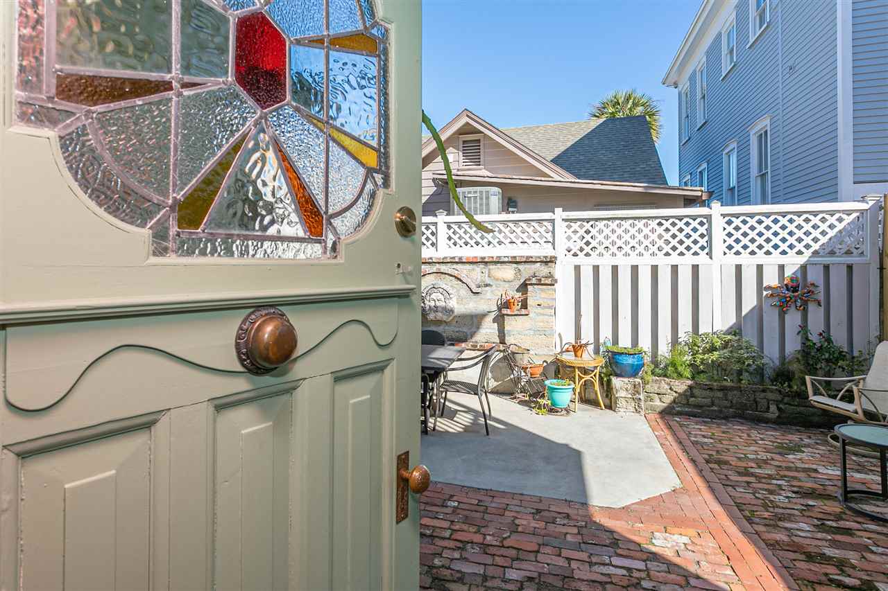 63 Marine Street St. Augustine, FL 32084 - Photo 9 of 42 a backyard of a house with table and chairs