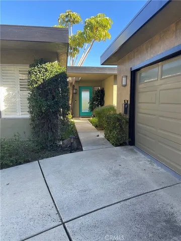 a view of a house with potted plants