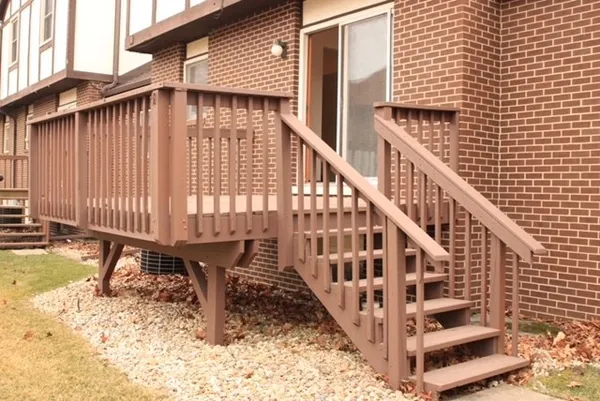 a view of a house with a wooden deck