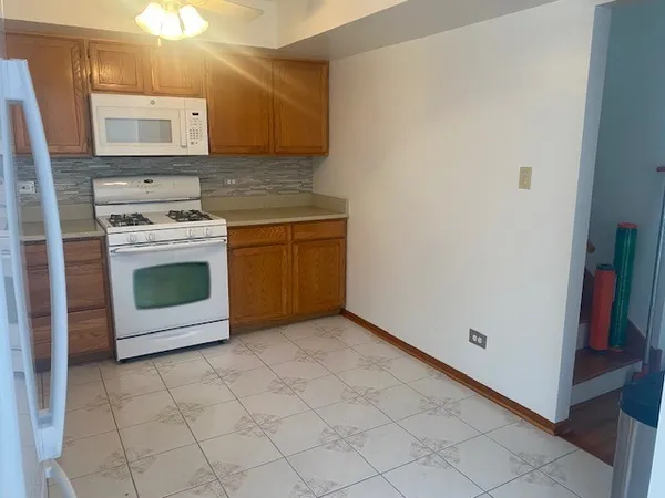 a kitchen with a stove top oven and cabinets