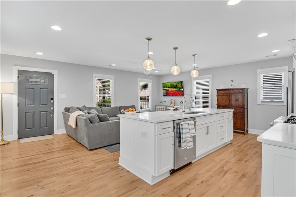 114 Tye Street Southeast Atlanta, GA 30316 - Photo 12 of 48 a large white kitchen with wooden floor and stainless steel appliances