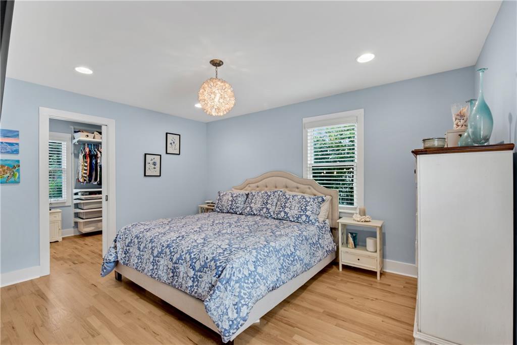 114 Tye Street Southeast Atlanta, GA 30316 - Photo 18 of 48 a bedroom with a bed and dresser with wooden floor