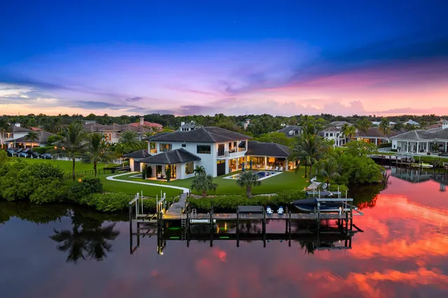 a view of a patio with table and chairs under an umbrella and a fire pit