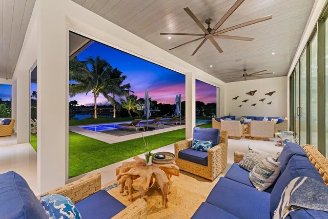 a bedroom with a balcony a bed and a flat screen tv