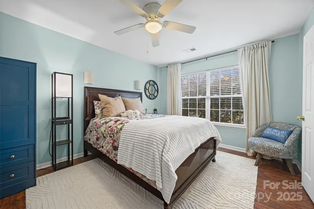 a bedroom with a bed lamps and a large mirror