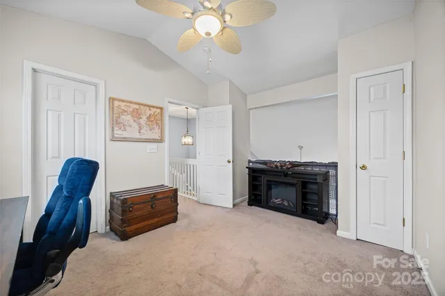 a view of an empty room with furniture and a fireplace