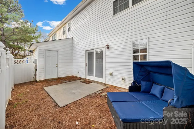 a view of a backyard with furniture and a garage