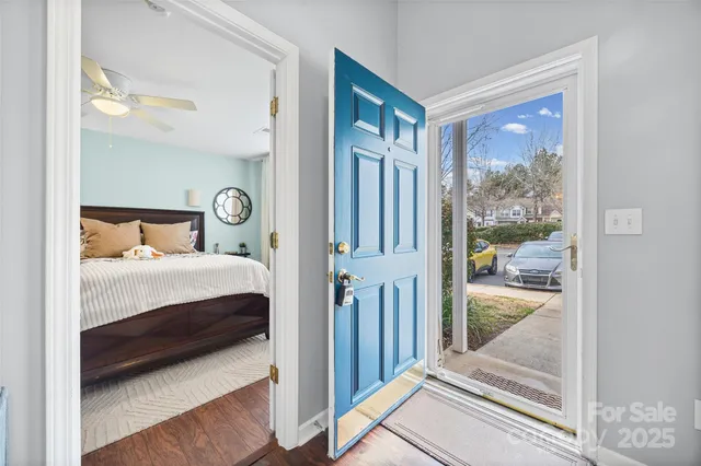 a bedroom with a bed and glass door