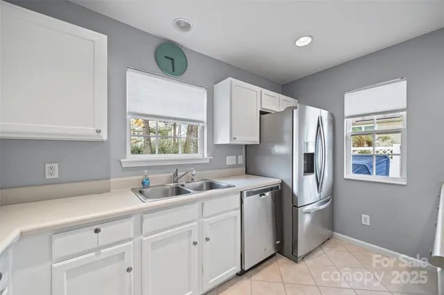 a kitchen with stainless steel appliances a refrigerator sink and cabinets