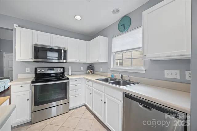 a kitchen with a sink stove and microwave