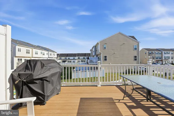 a view of a deck with table and chairs with wooden floor and fence