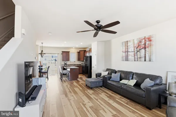 a view of a livingroom with wooden floor and stairs
