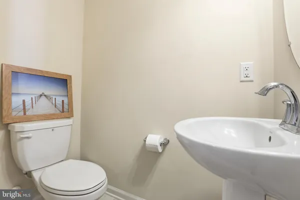 a white toilet sitting next to a bathroom sink