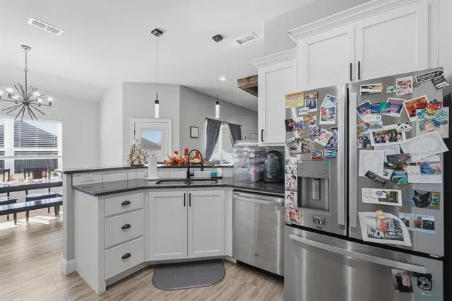 a kitchen with stainless steel appliances granite countertop a sink and cabinets