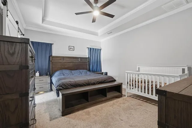a bedroom with a bed and a ceiling fan