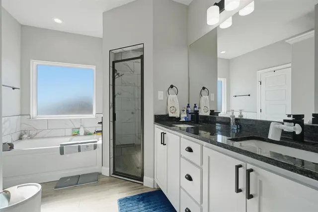 a bathroom with a granite countertop sink mirror and vanity