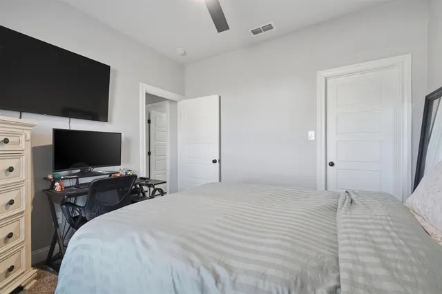 a bedroom with a flat screen tv and a bed