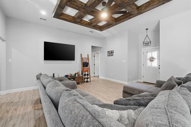 a bedroom with furniture and a flat screen tv
