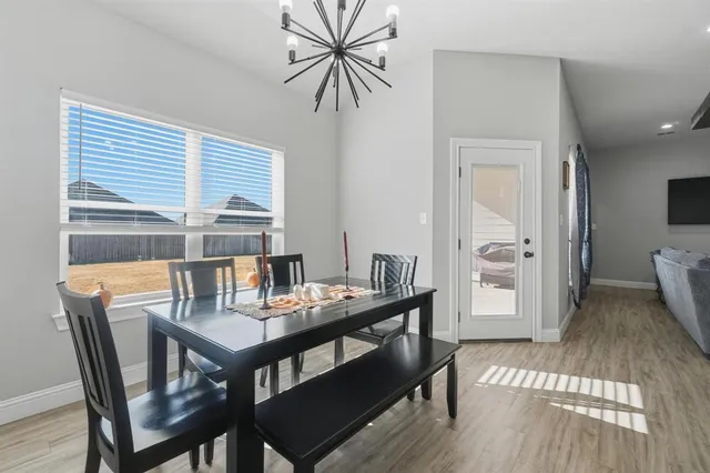 a view of a dining room with furniture and window