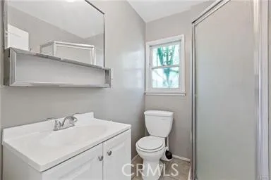 a white toilet sitting next to a bathroom sink