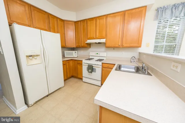 a kitchen with a refrigerator a sink and a stove