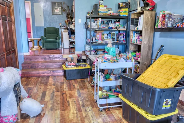 a utility room with lots of clutter and toys
