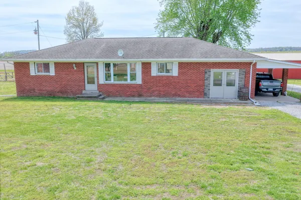 a front view of a house with a garden and porch