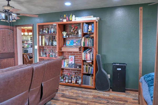 a living room with lots of furniture and a book shelf