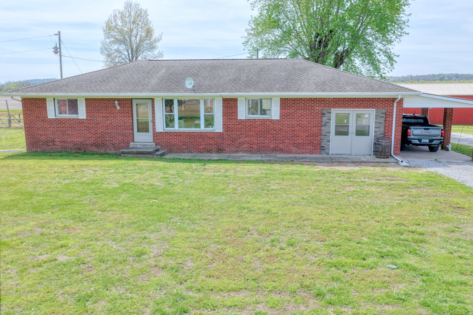 3992 Neunert Road Jacob, IL 62950 - Photo 3 of 48 a front view of a house with a garden and porch