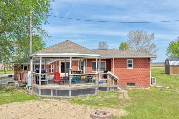 a front view of a house with a yard table and chairs