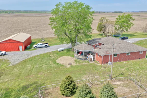 a aerial view of a house with table and chairs