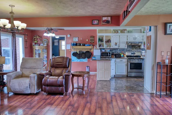 a living room with furniture and wooden floor