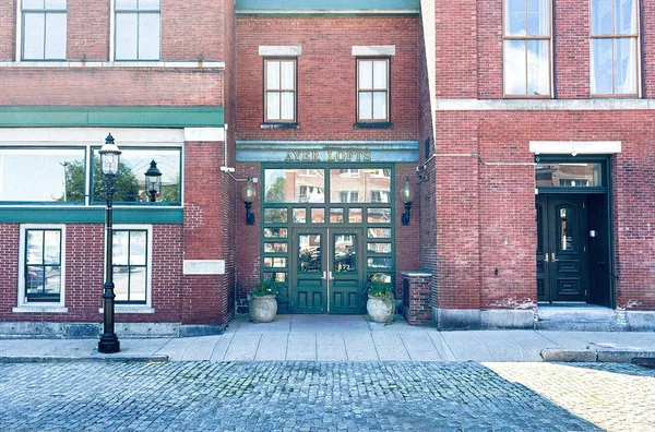 a front view of a brick building with many windows