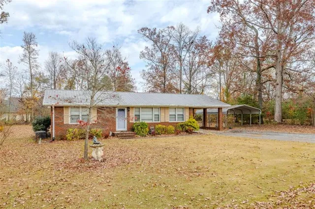 a patio with a table and chairs under an umbrella