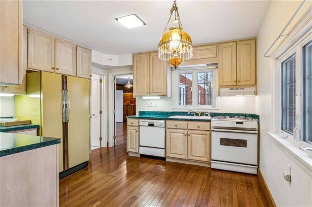 2508 Woodbine Road Aliquippa, PA 15001 - Photo 11 of 46 a kitchen with stainless steel appliances a stove a refrigerator a sink and dishwasher with wooden floor