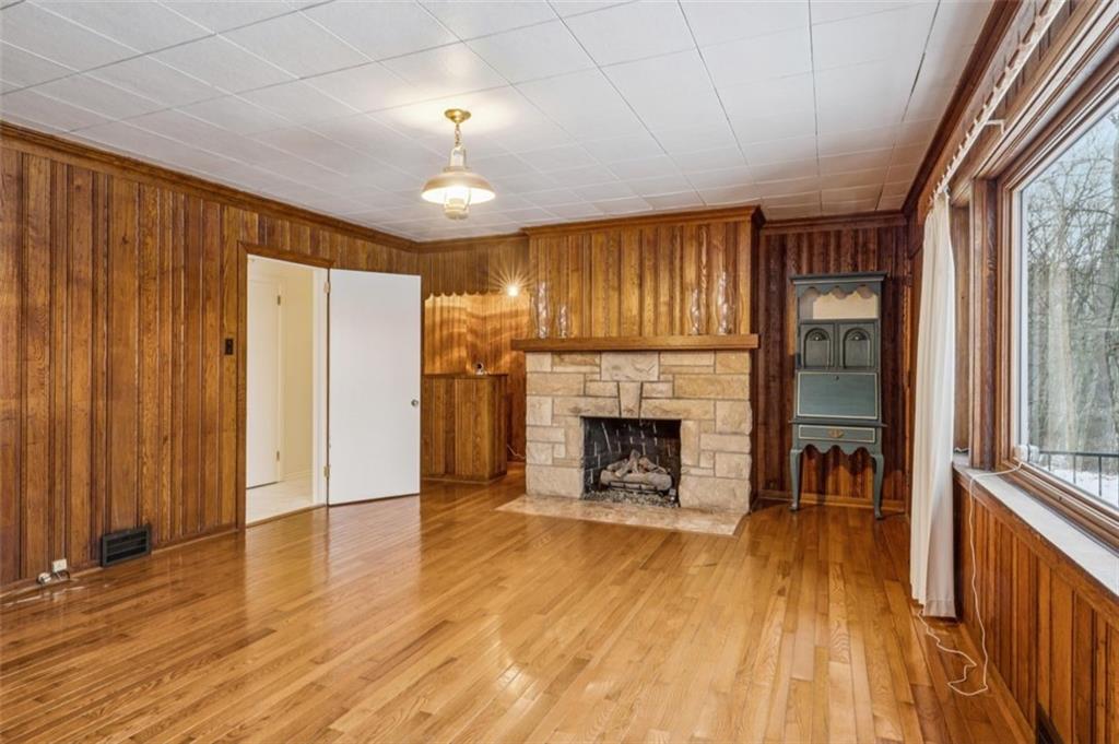 2508 Woodbine Road Aliquippa, PA 15001 - Photo 14 of 46 wooden floor fireplace and windows in an empty room