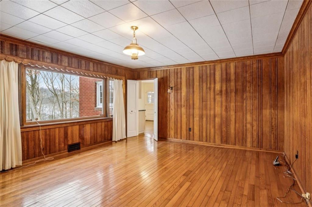 2508 Woodbine Road Aliquippa, PA 15001 - Photo 17 of 46 an empty room with wooden floor and windows
