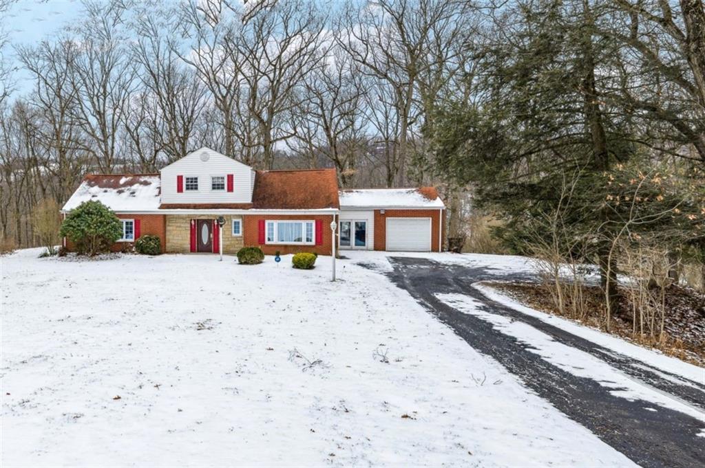 2508 Woodbine Road Aliquippa, PA 15001 - Photo 44 of 46 a front view of a house with a yard covered with snow