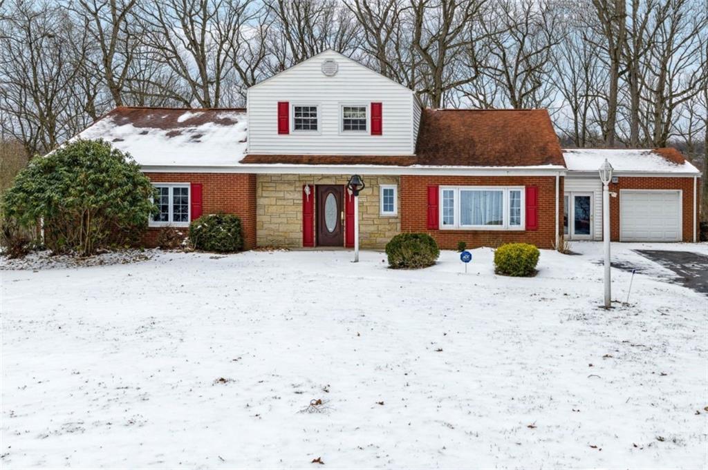 2508 Woodbine Road Aliquippa, PA 15001 - Photo 45 of 46 a view of a white house with a yard covered in it