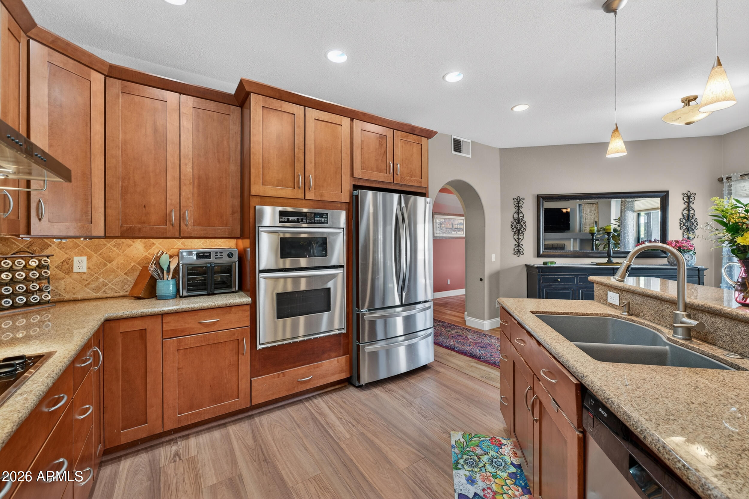 1539 East Winged Foot Road Phoenix, AZ 85022 - Photo 21 of 64 a kitchen with stainless steel appliances granite countertop a sink refrigerator and microwave