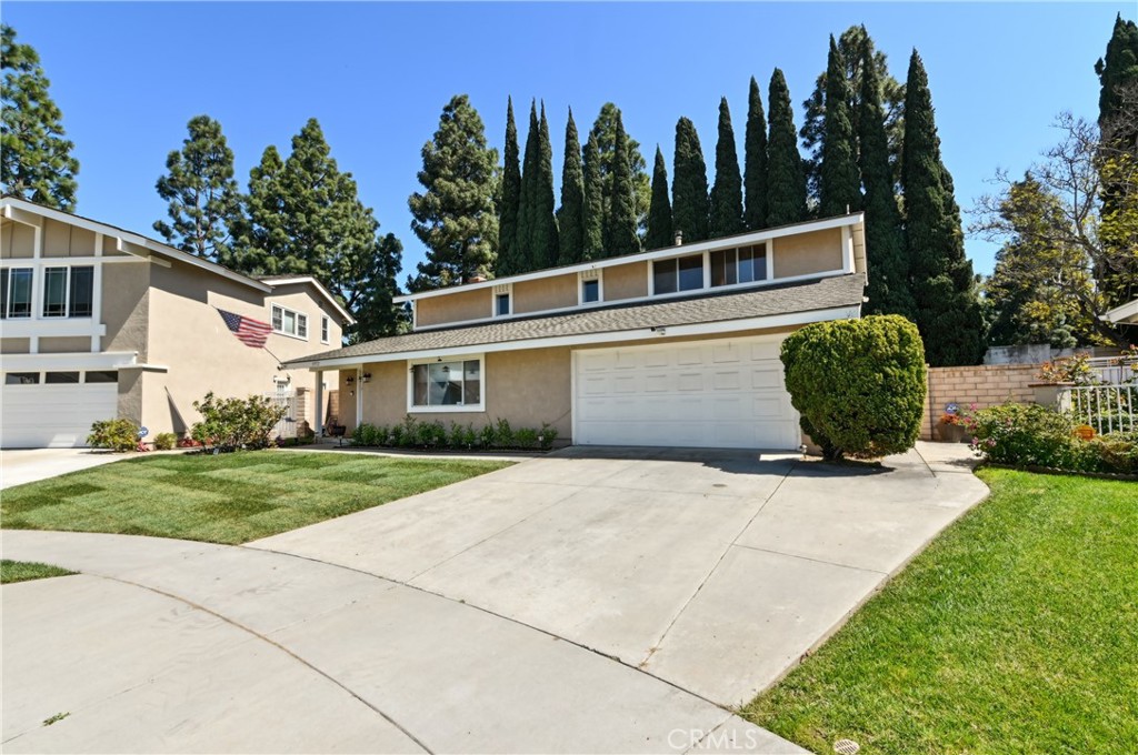 3972 Hendrix Street Irvine, CA 92614 - Photo 3 of 3 a view of a white house with a yard and a garden