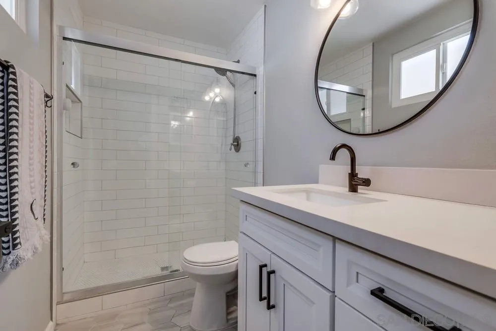 10262 Molino Road Santee, CA 92071 - Photo 17 of 26 a bathroom with a sink a toilet a mirror and shower