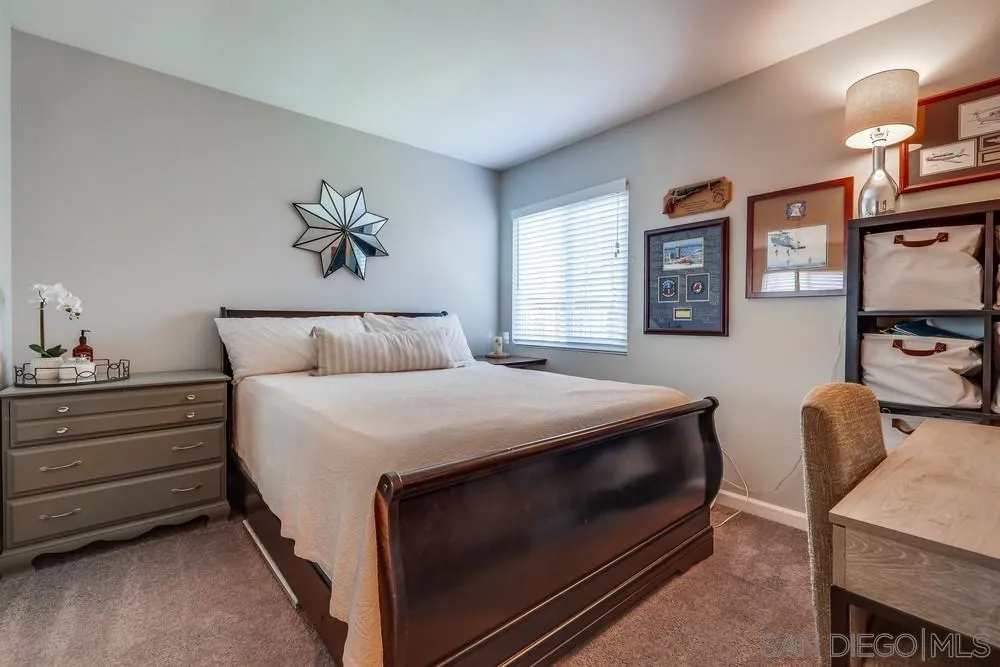 10262 Molino Road Santee, CA 92071 - Photo 19 of 26 a bedroom with a bed and a chandelier