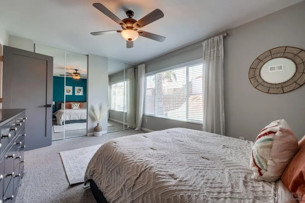 10262 Molino Road Santee, CA 92071 - Photo 20 of 26 a bedroom with a bed and a chandelier