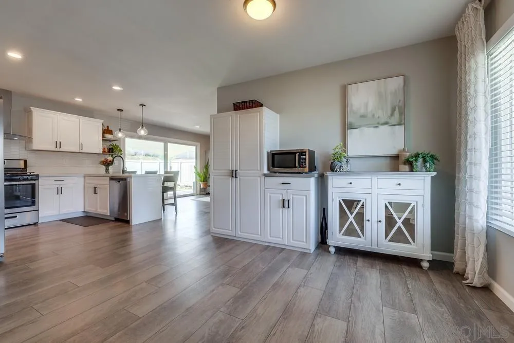 10262 Molino Road Santee, CA 92071 - Photo 4 of 26 a kitchen with stainless steel appliances a stove top oven